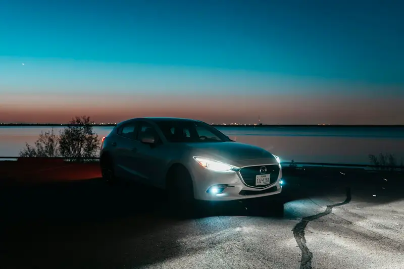 Silver Mazda 3 sedan at dusk